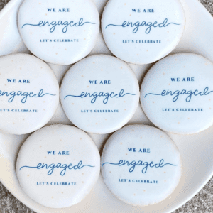 A plate of cookies that say " we are engaged ".
